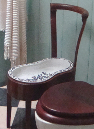 antique porcelain bidet in wooden chair frame